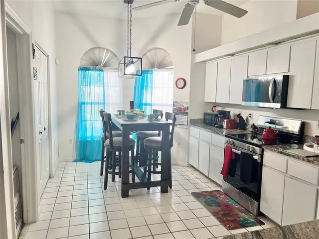 a kitchen with stainless steel appliances granite countertop a sink a stove and a refrigerator