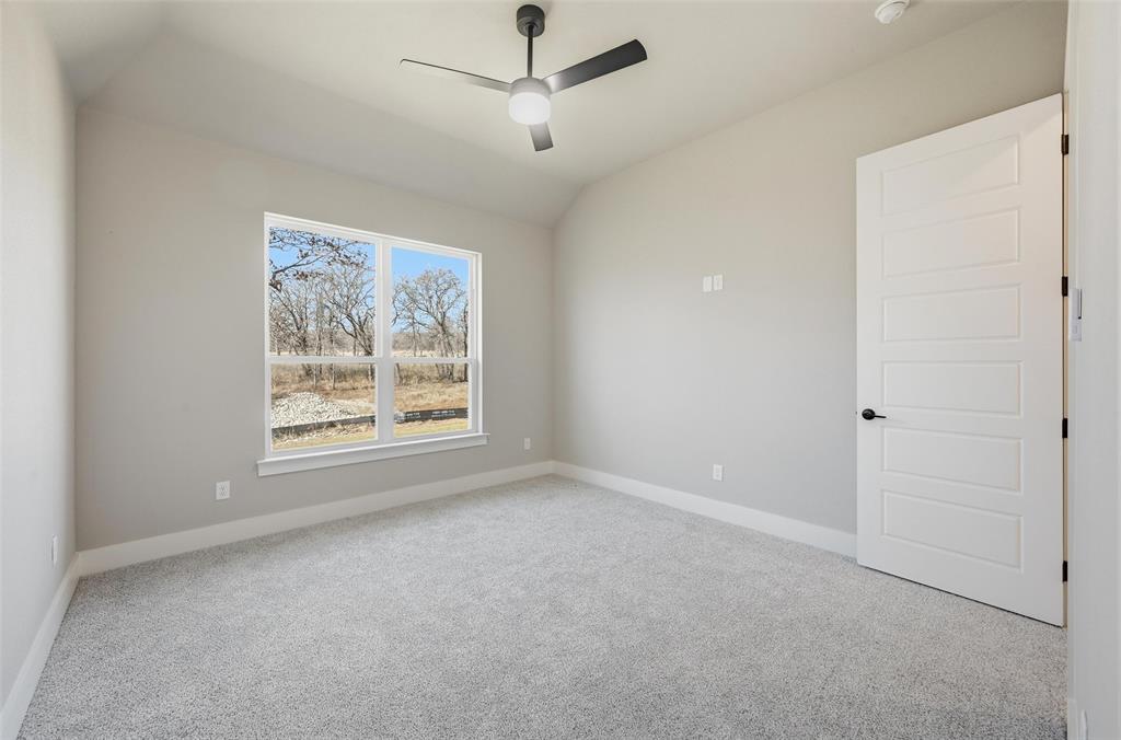 1053 Llano Way Poolville, TX 76487 - Photo 33 of 40 an empty room with a window and a ceiling fan