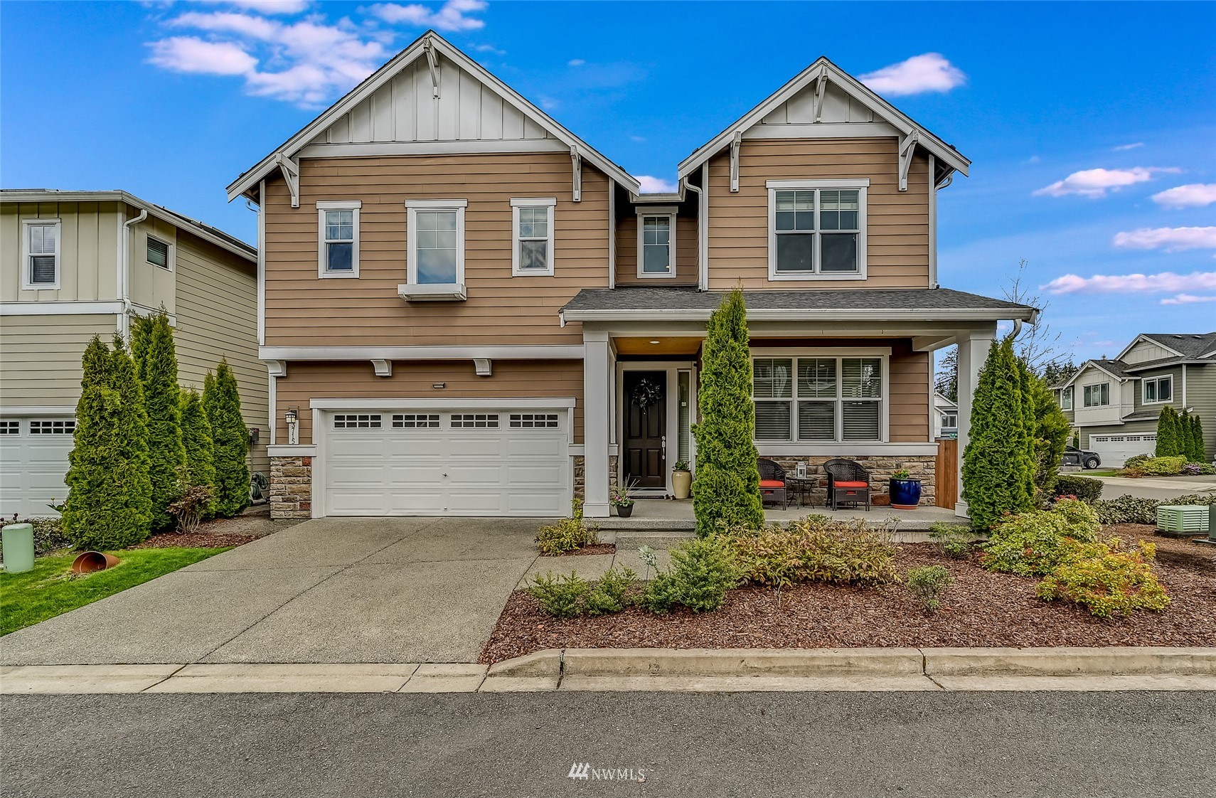 3715 195th Place Southeast Bothell, WA 98012 - Photo 1 of 28 a front view of a house with a yard and garage