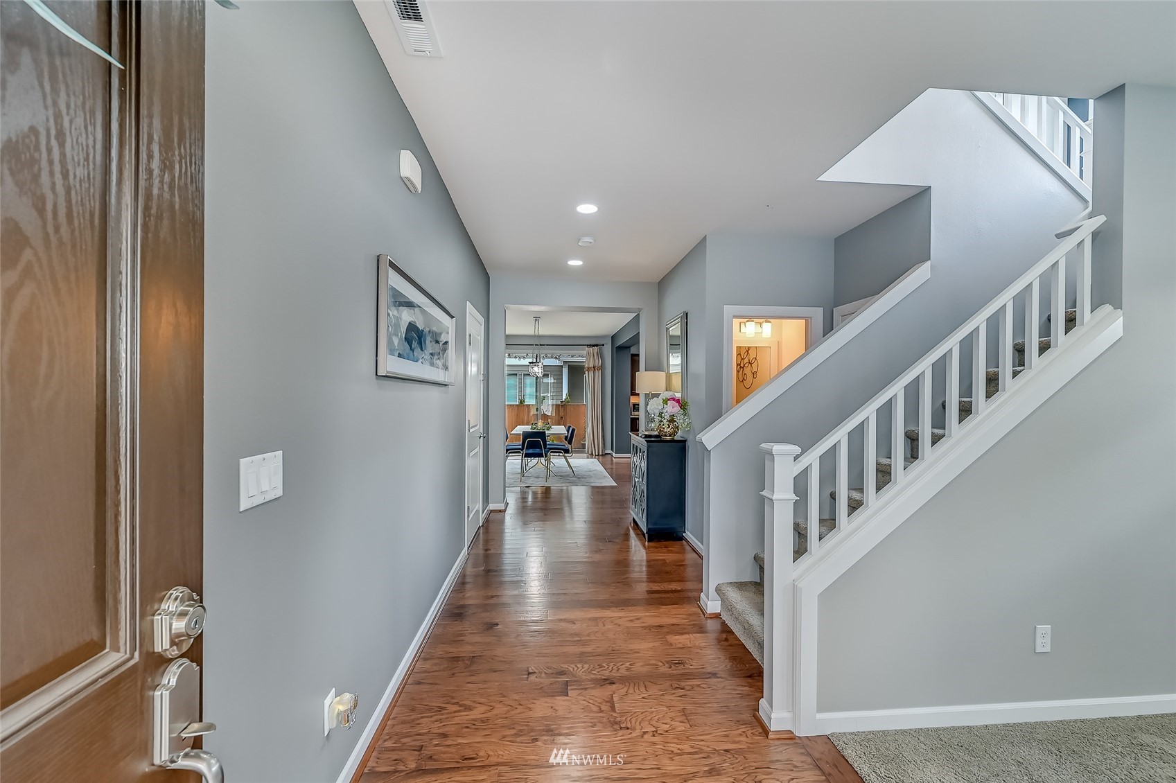 3715 195th Place Southeast Bothell, WA 98012 - Photo 4 of 28 a view of staircase with lots of frames on wall and a dining table