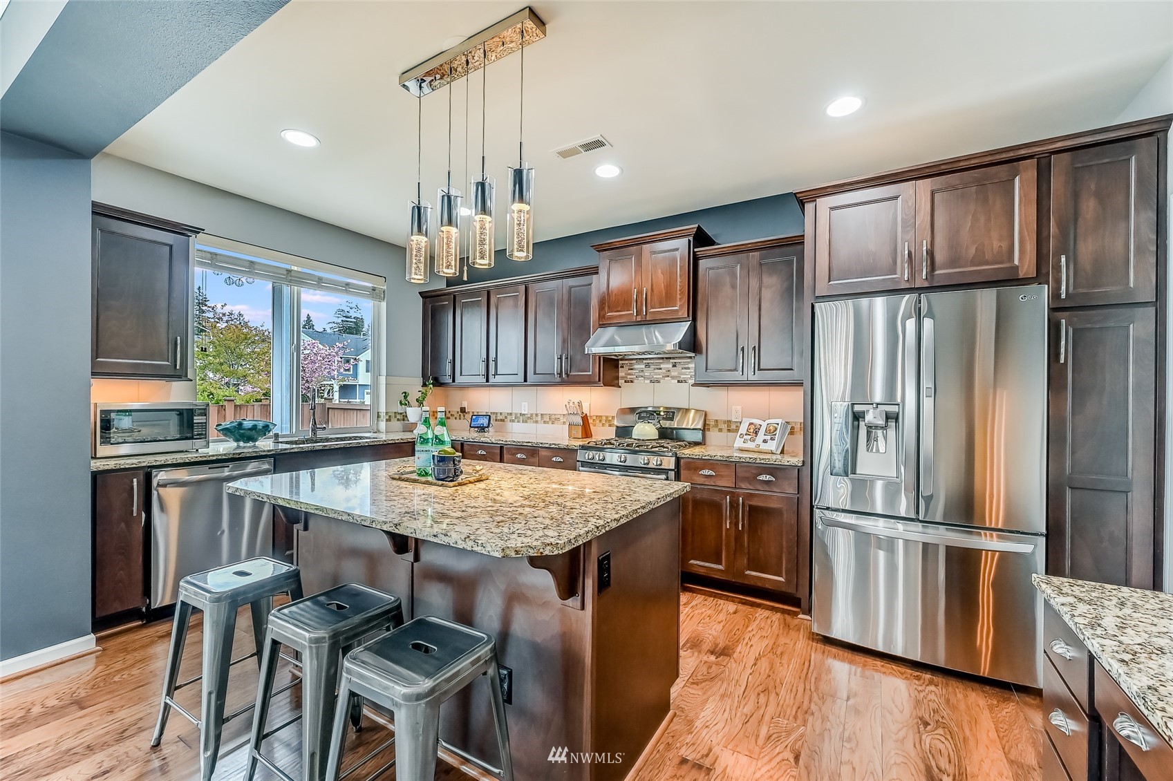 3715 195th Place Southeast Bothell, WA 98012 - Photo 10 of 28 a kitchen with granite countertop a refrigerator stove top oven and sink
