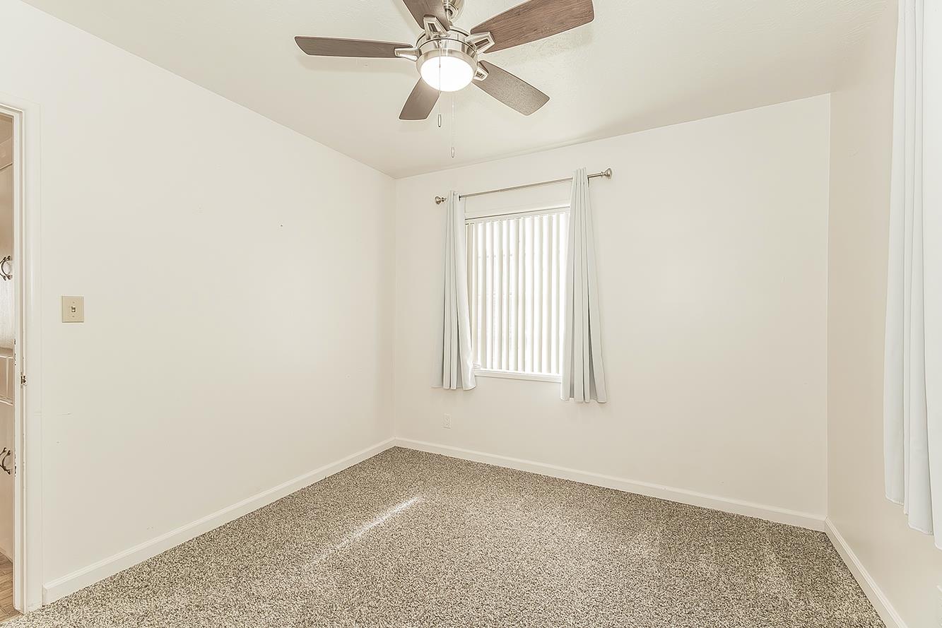 795 West Palm Avenue Reedley, CA 93654 - Photo 16 of 28 an empty room with windows and fan