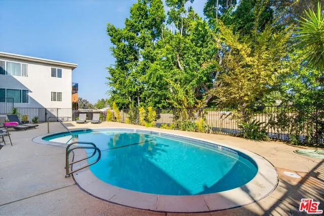 a swimming pool with outdoor seating and yard
