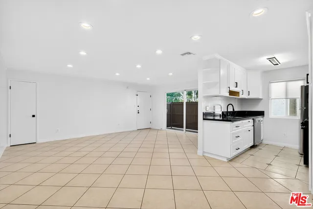 a kitchen with stainless steel appliances a refrigerator sink and cabinets