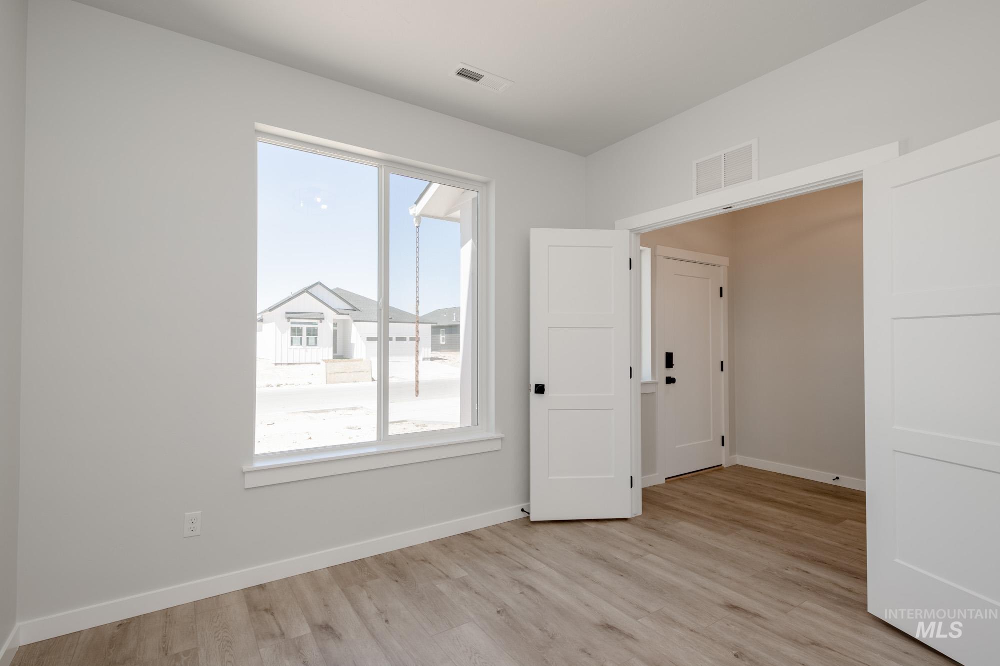 6596 South Banded Eagle Way Boise, ID 83709 - Photo 14 of 28 Spare room with healthy amount of natural light and light wood-style flooring