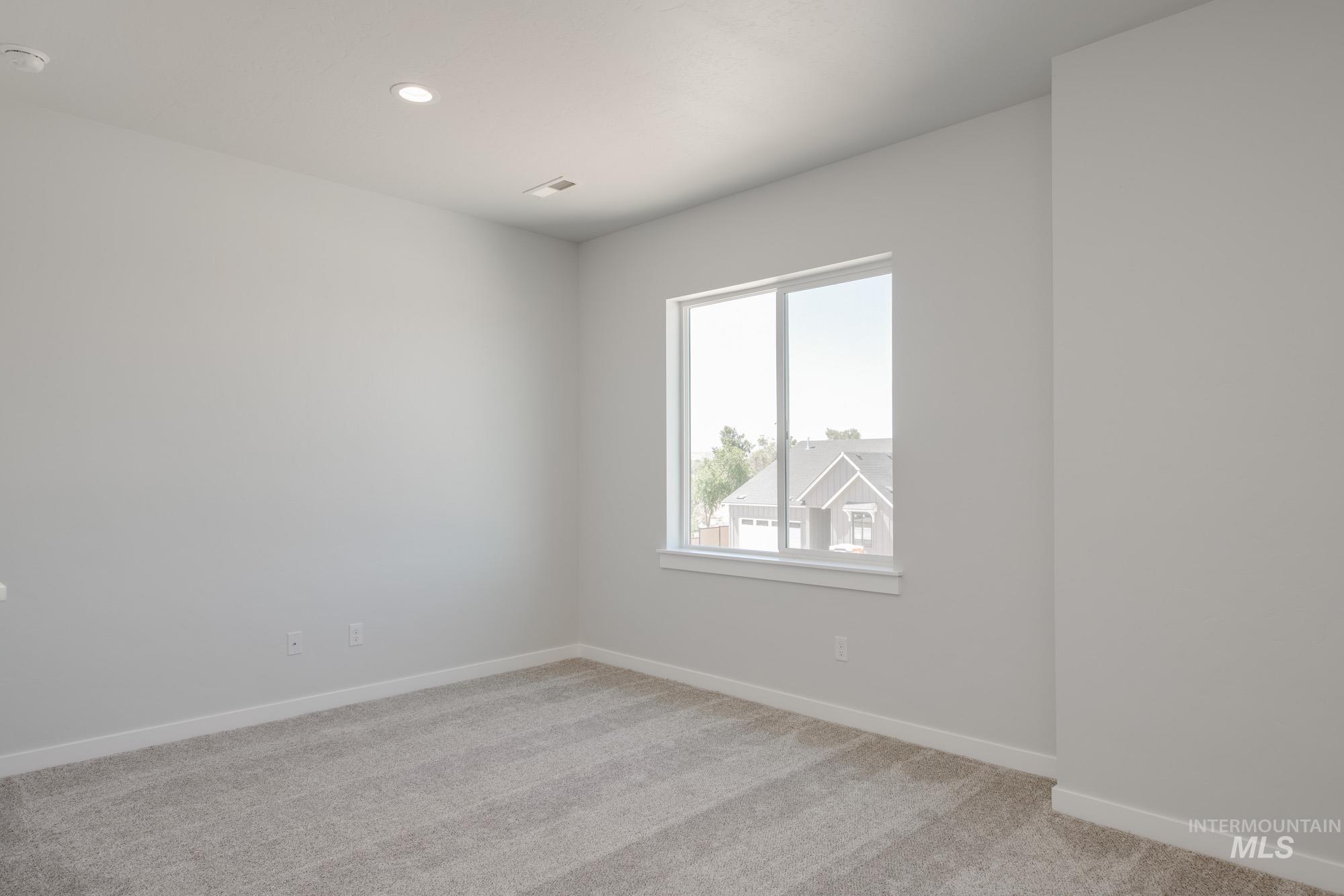 6596 South Banded Eagle Way Boise, ID 83709 - Photo 18 of 28 Spare room with light colored carpet, recessed lighting, and a smoke detector