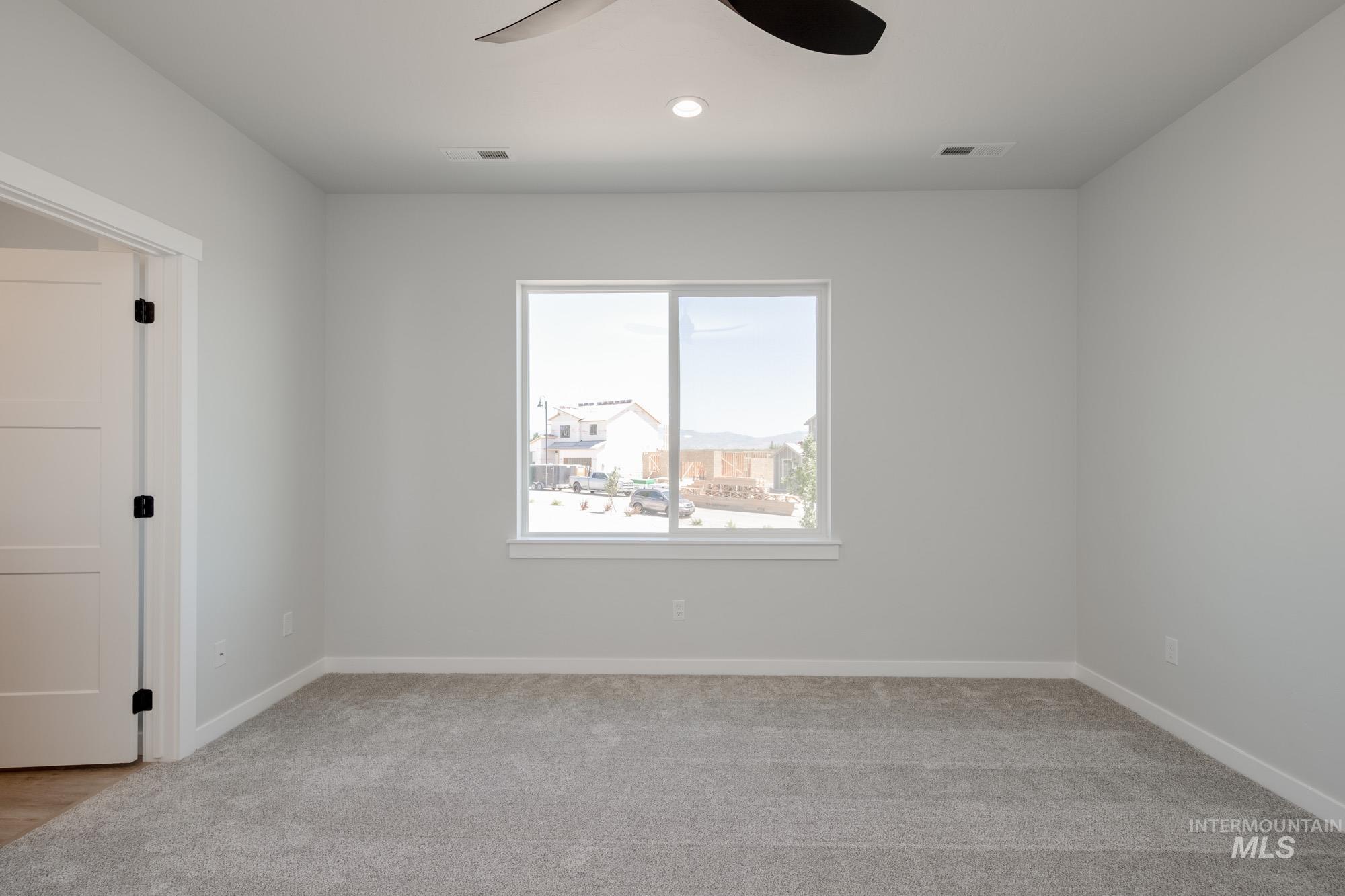 6596 South Banded Eagle Way Boise, ID 83709 - Photo 19 of 28 Spare room with a ceiling fan, light carpet, and recessed lighting