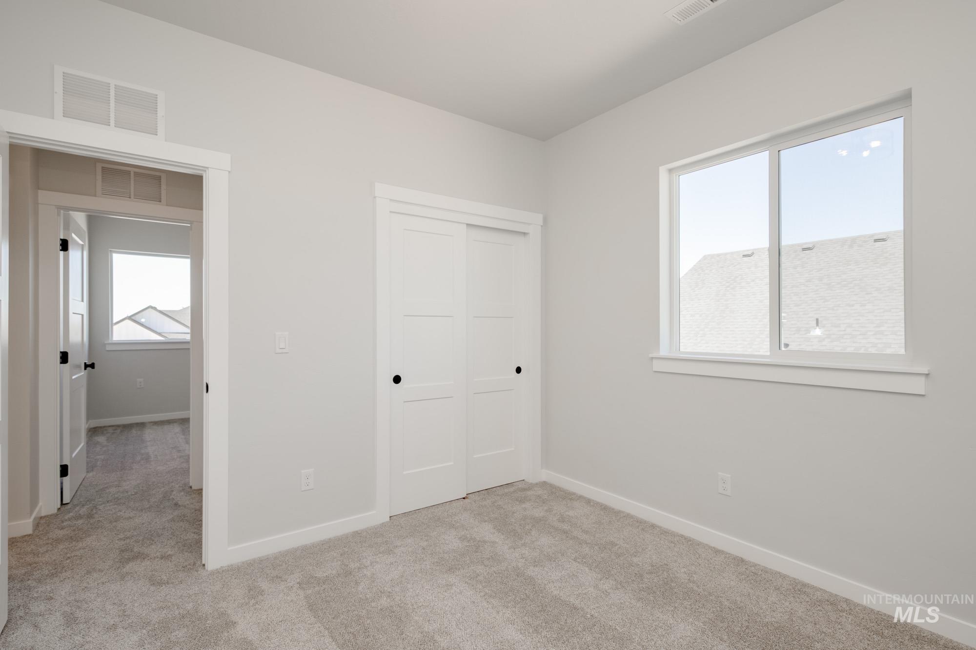 6596 South Banded Eagle Way Boise, ID 83709 - Photo 25 of 28 Unfurnished bedroom featuring light carpet and a closet