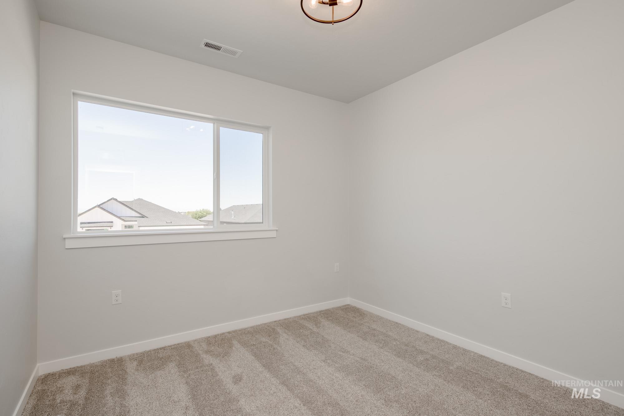 6596 South Banded Eagle Way Boise, ID 83709 - Photo 26 of 28 Empty room featuring carpet floors and baseboards