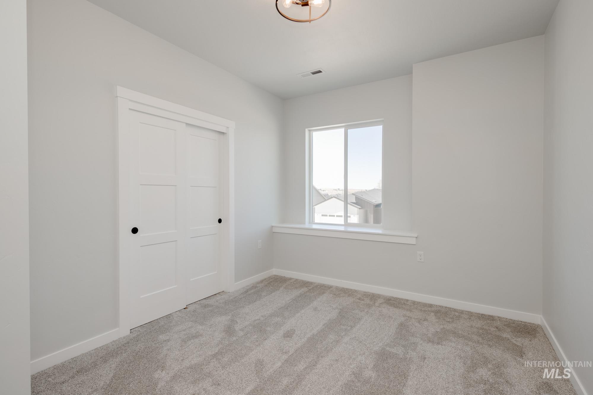 6596 South Banded Eagle Way Boise, ID 83709 - Photo 27 of 28 Unfurnished bedroom with carpet and a closet
