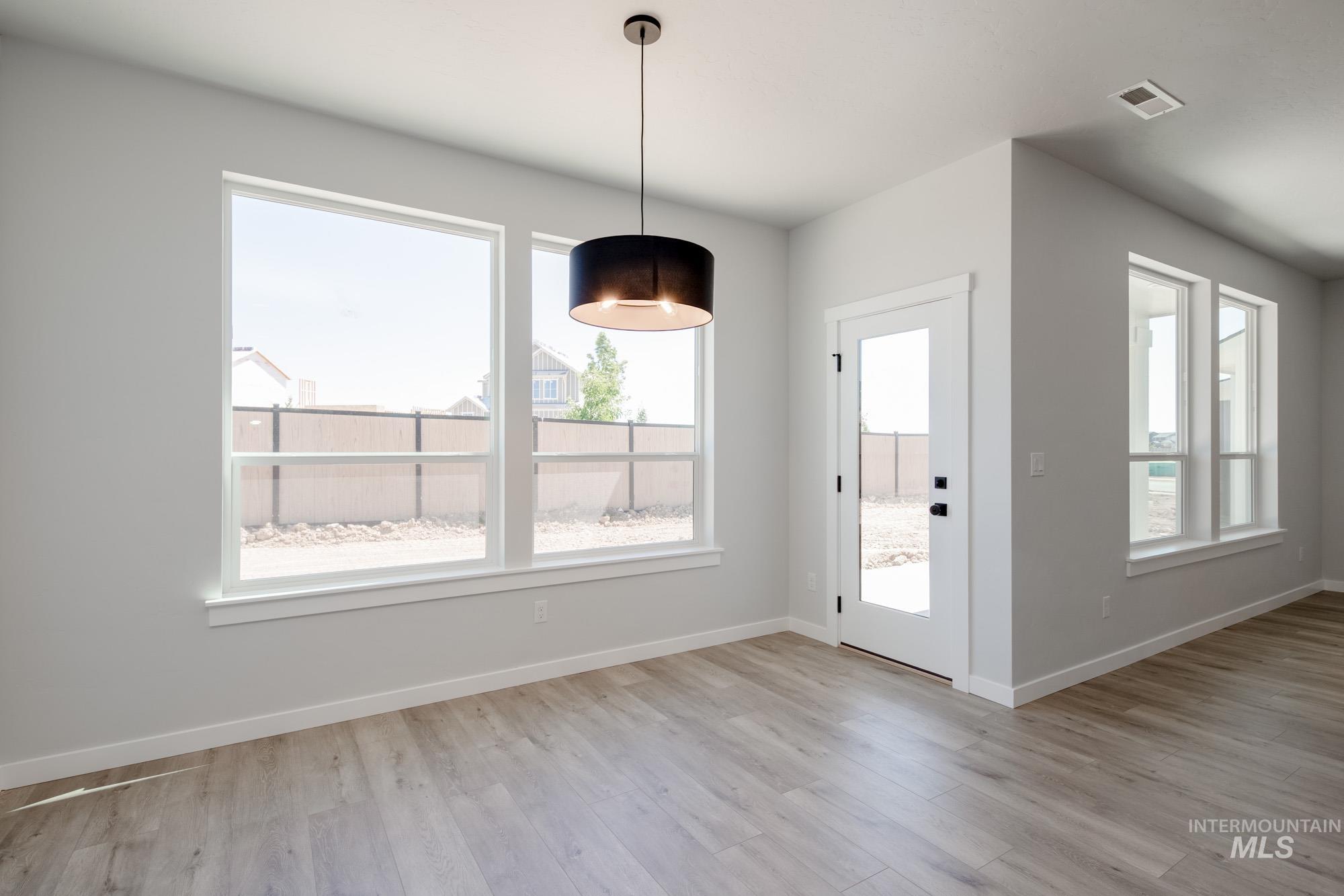 6596 South Banded Eagle Way Boise, ID 83709 - Photo 9 of 28 Unfurnished dining area with healthy amount of natural light and light wood-style flooring