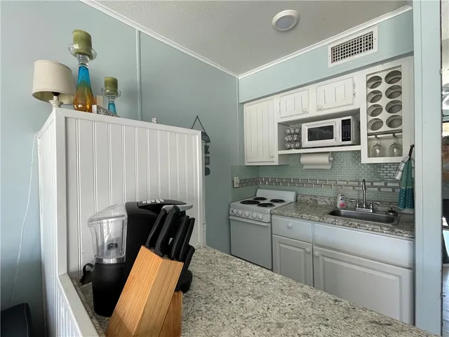 a kitchen with stainless steel appliances granite countertop a stove and a refrigerator
