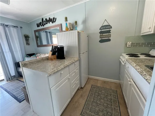 a kitchen with granite countertop a sink stainless steel appliances and cabinets