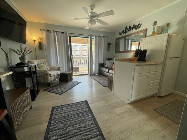 a living room with furniture a window and gym equipment
