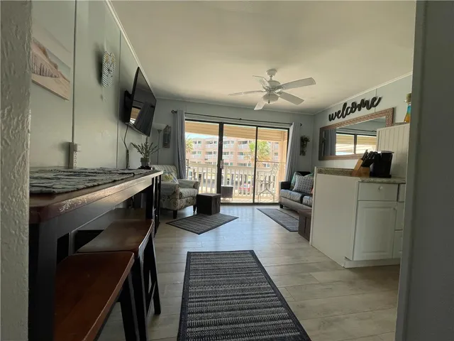 a kitchen with sink stove and refrigerator