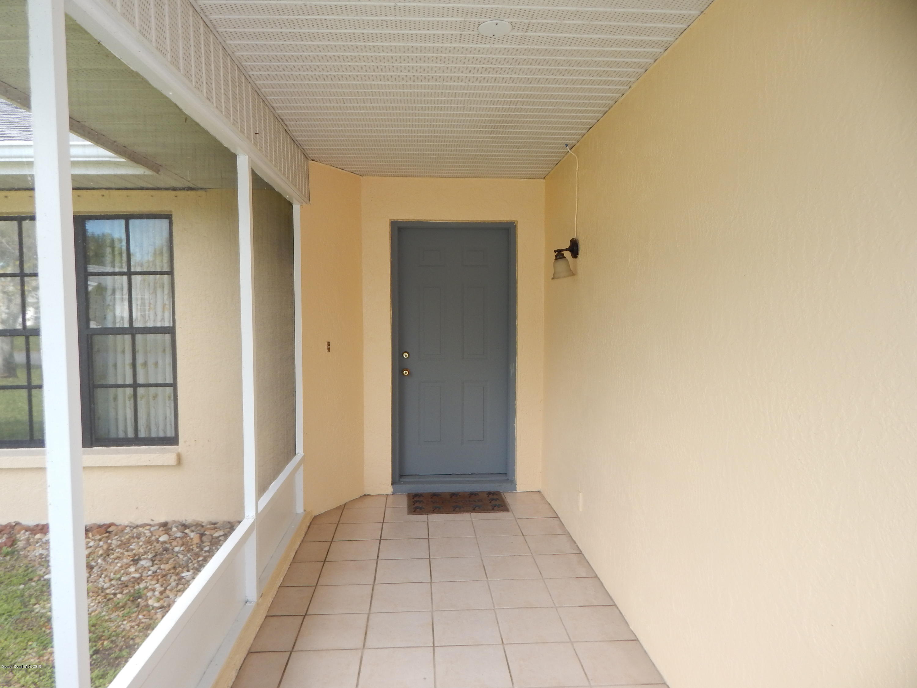 1247 Winding Meadows Road Rockledge, FL 32955 - Photo 4 of 23 Front door enclosed porch