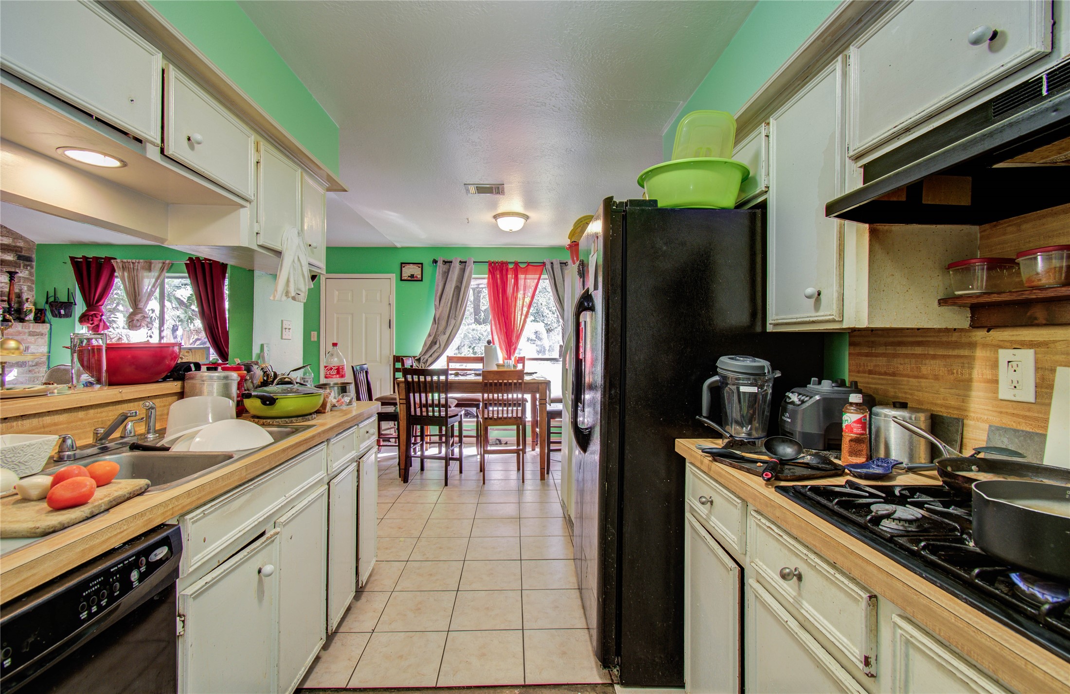 22315 Indian Ridge Drive Katy, TX 77450 - Photo 11 of 29 a kitchen with a sink a stove and chairs