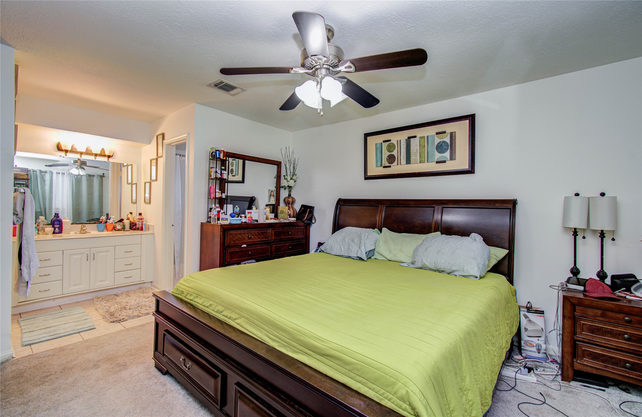 22315 Indian Ridge Drive Katy, TX 77450 - Photo 16 of 29 a bedroom with a large bed and a chandelier