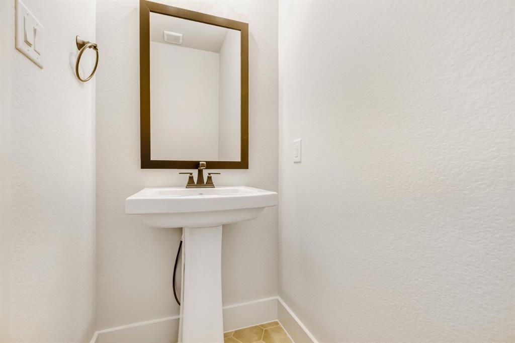 3328 Chinaberry Street Celina, TX 75009 - Photo 11 of 29 a bathroom with a sink and mirror