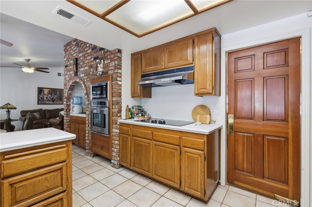 18233 Charlton Lane Porter Ranch, CA 91326 - Photo 35 of 40 a kitchen with stainless steel appliances granite countertop a stove and a sink
