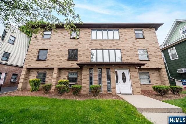 141 Park Avenue, Unit 8A East Rutherford, NJ 07073 - Photo 20 of 22 a front view of a house with garden