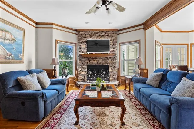 a living room with furniture a flat screen tv and a fireplace