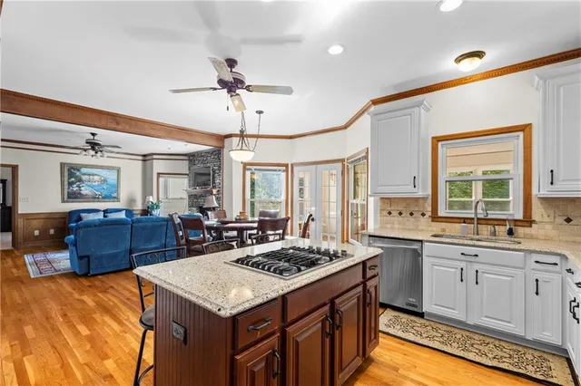 a kitchen with a stove a sink dishwasher and a refrigerator