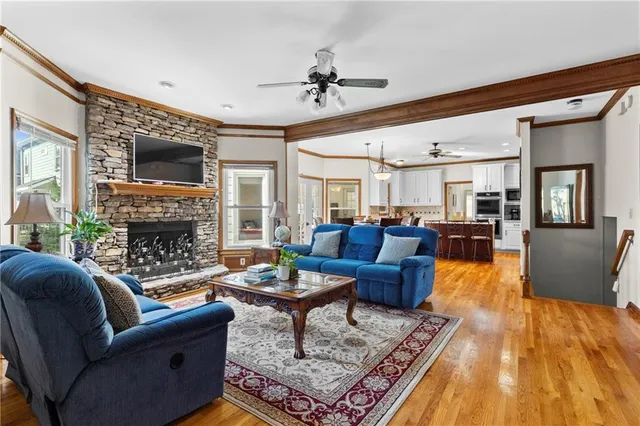 a living room with furniture a fireplace and a flat screen tv