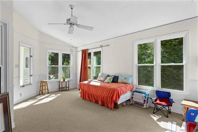 a bedroom with a bed chair and window