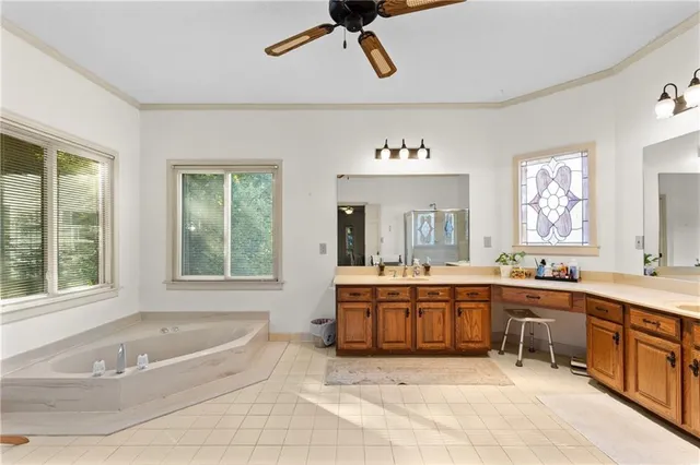 a large white kitchen with a large window