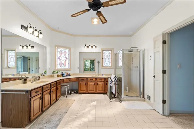 a large bathroom with a large tub shower and sink