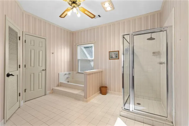a spacious bathroom with a double vanity sink a mirror and a shower