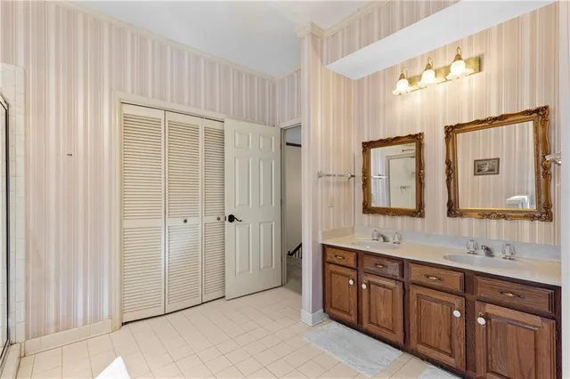 a bedroom with bed and a book shelf