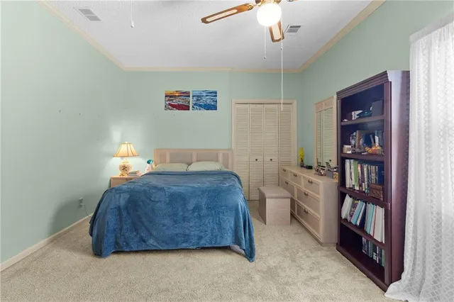 a view of a workspace with furniture and a bookshelf