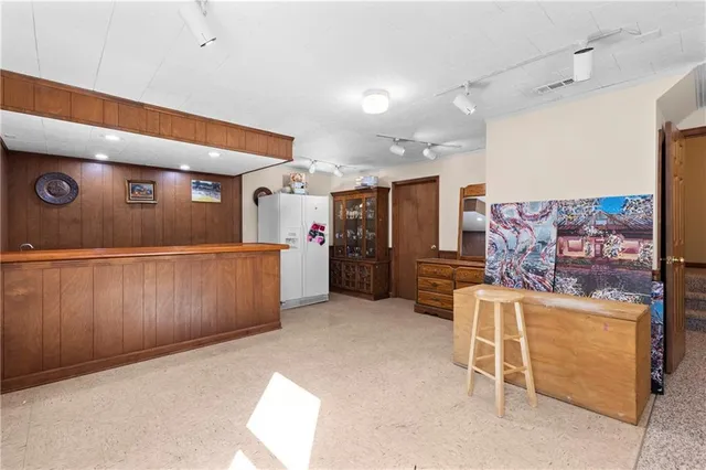 a living room with furniture and kitchen view