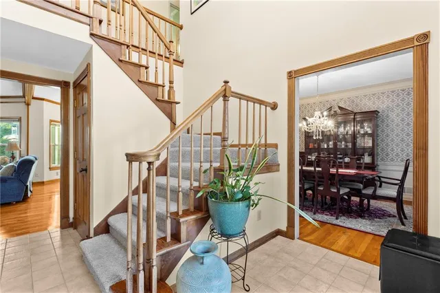 a view of staircase with furniture and a potted plant