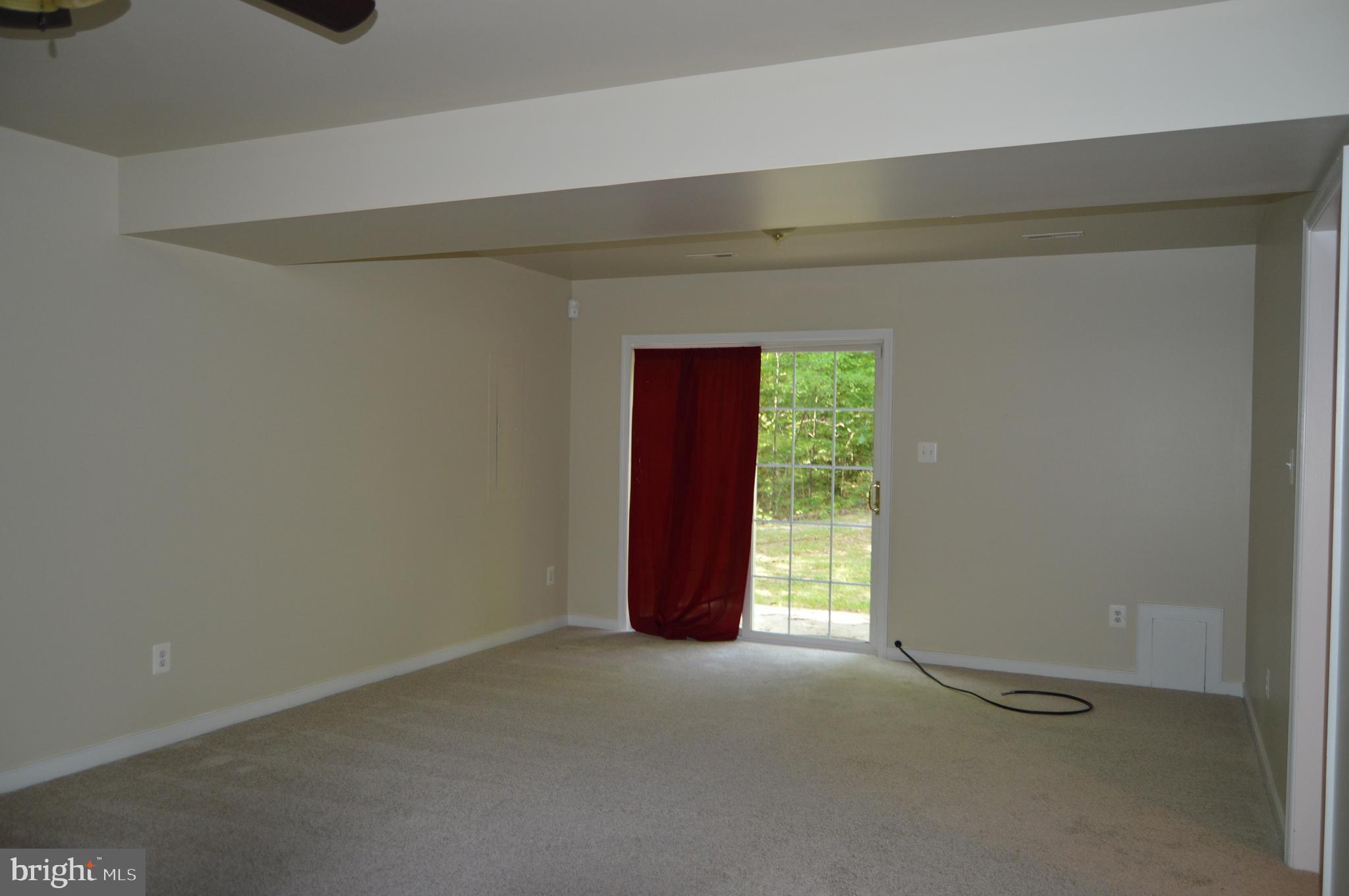 12137 Shortleaf Road Ruther Glen, VA 22546 - Photo 18 of 22 Family room with slider onto small patio