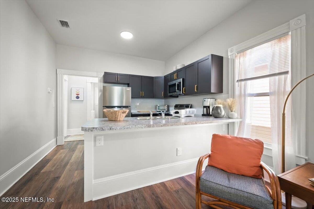 1946 Redell Street Jacksonville, FL 32206 - Photo 12 of 28 a kitchen with stainless steel appliances granite countertop a refrigerator and a stove top oven