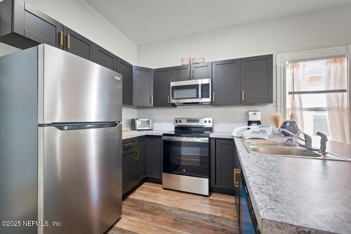 1946 Redell Street Jacksonville, FL 32206 - Photo 13 of 28 a kitchen with granite countertop a refrigerator stove and sink
