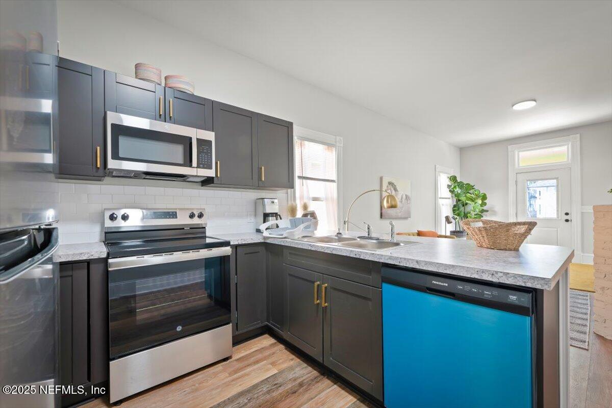 1946 Redell Street Jacksonville, FL 32206 - Photo 14 of 28 a kitchen with stainless steel appliances granite countertop a sink stove and microwave