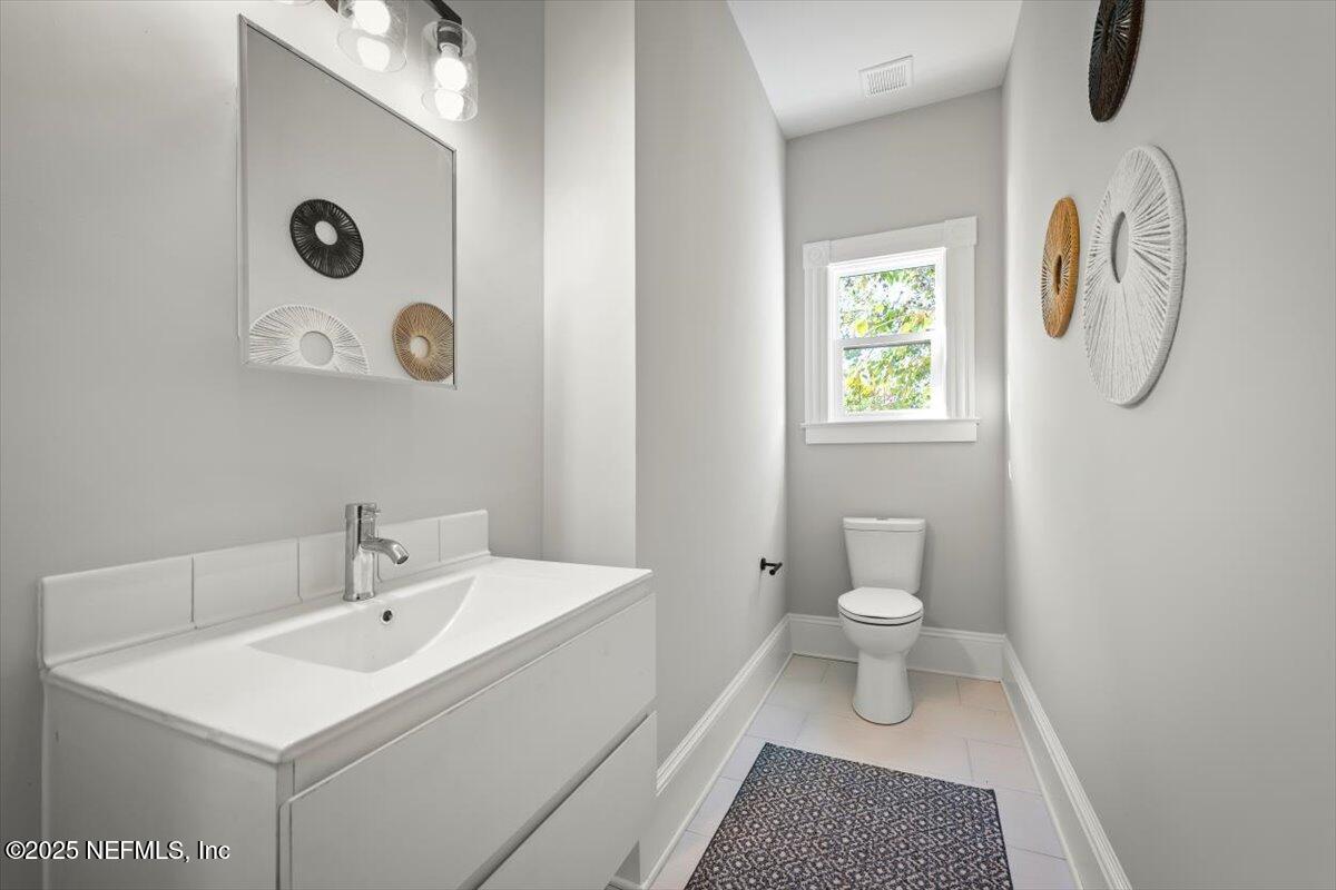 1946 Redell Street Jacksonville, FL 32206 - Photo 22 of 28 a bathroom with a sink a toilet and a mirror