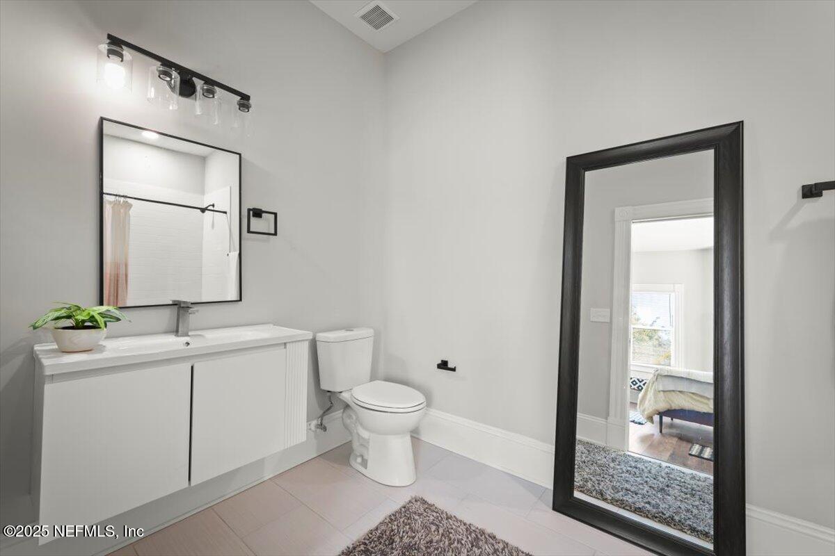 1946 Redell Street Jacksonville, FL 32206 - Photo 26 of 28 a bathroom with a toilet a sink and mirror