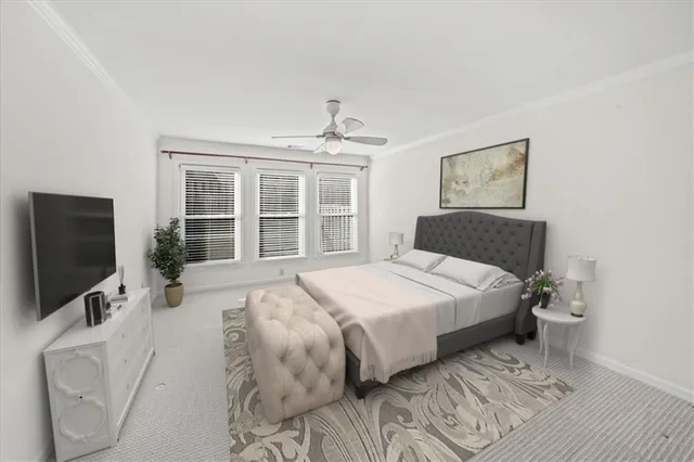 a bedroom with a large bed and a flat tv screen