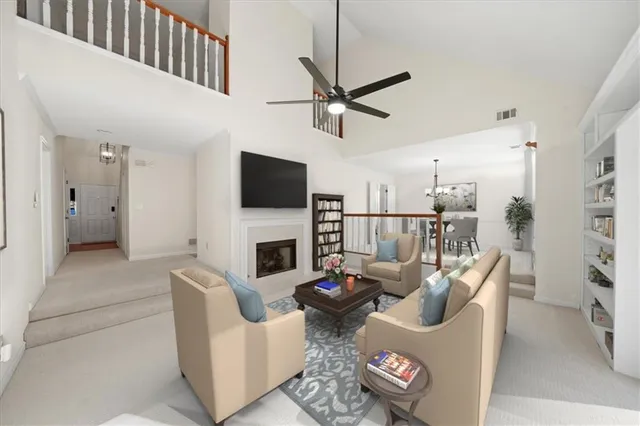 a living room with furniture a fireplace and a flat screen tv