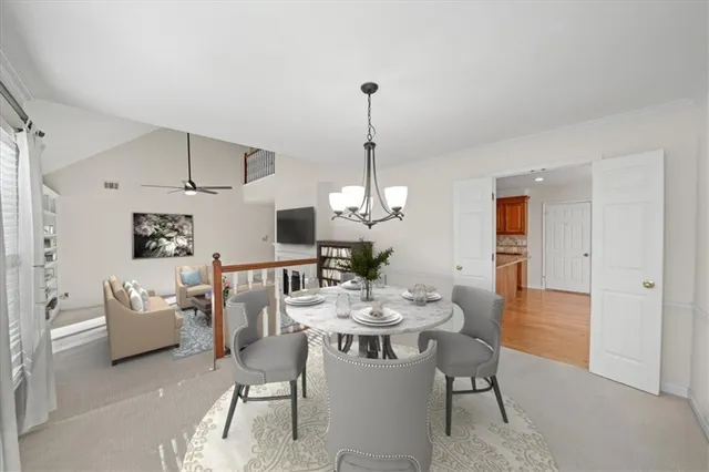 a dining room with furniture a chandelier and window