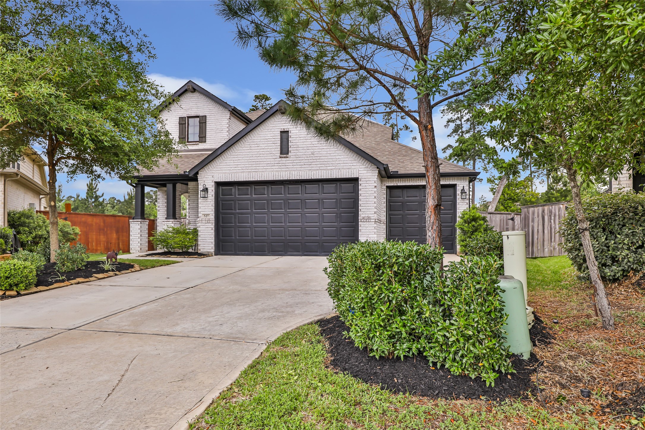 527 Chestnut Reef Court Conroe, TX 77304 - Photo 2 of 40 a front view of a house with garden