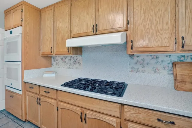 a dining room with furniture a window and wooden floor