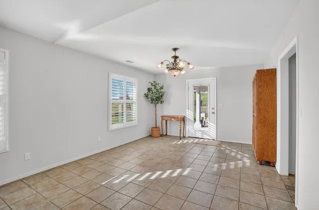 a bedroom with a bed and a chandelier fan
