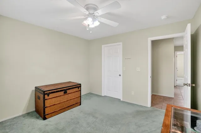 a bedroom with a bed a couch and a window