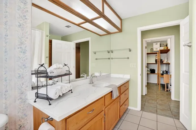 a bathroom with a double vanity sink a toilet and a mirror